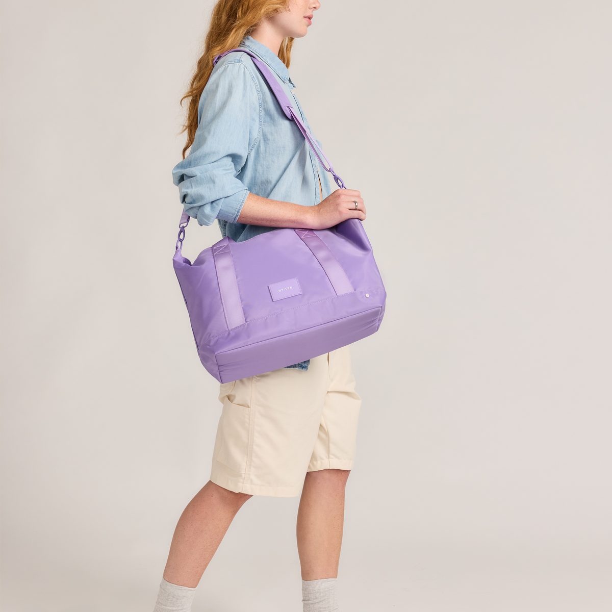 girl holding state bags graham tote purple