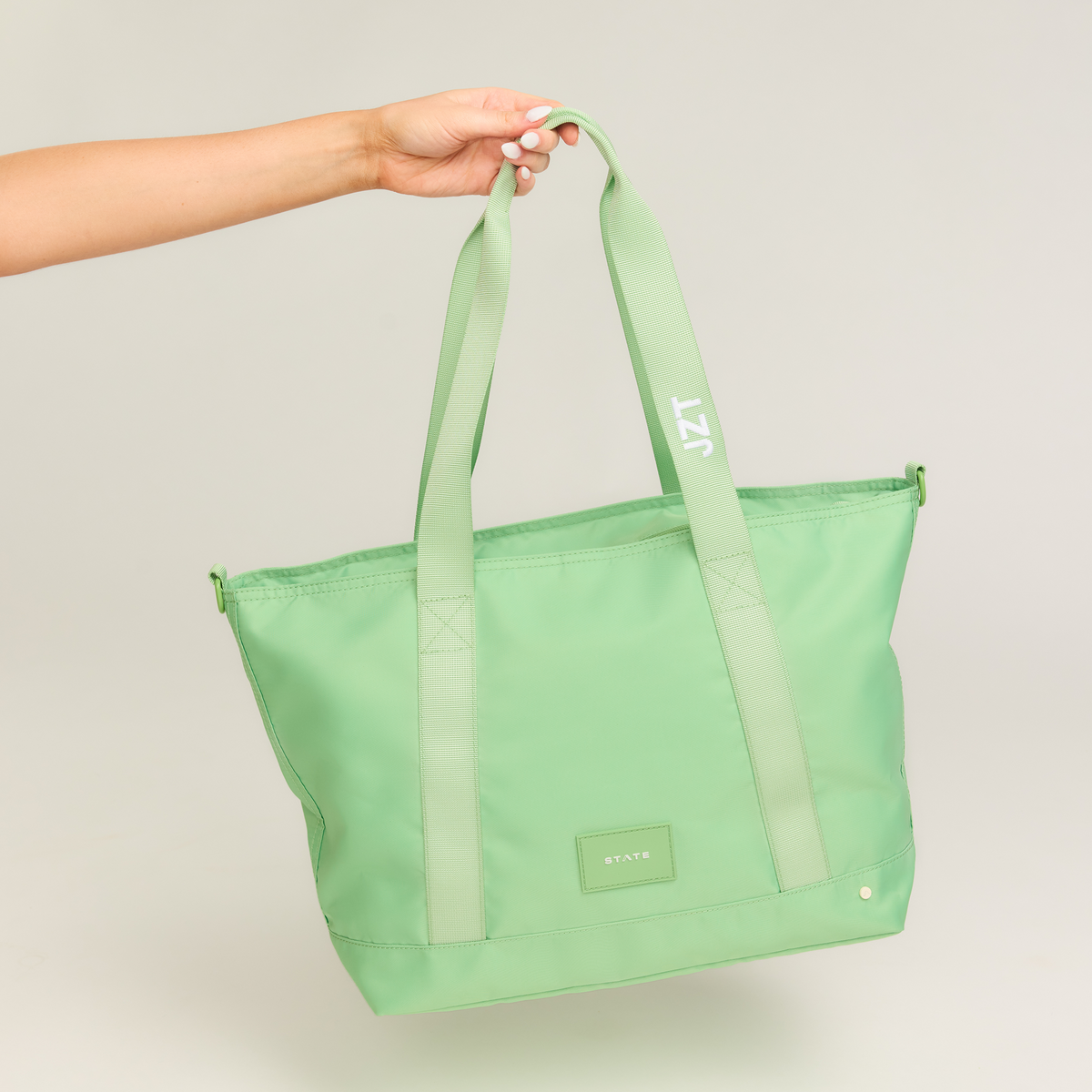 girl holding state bags graham tote green