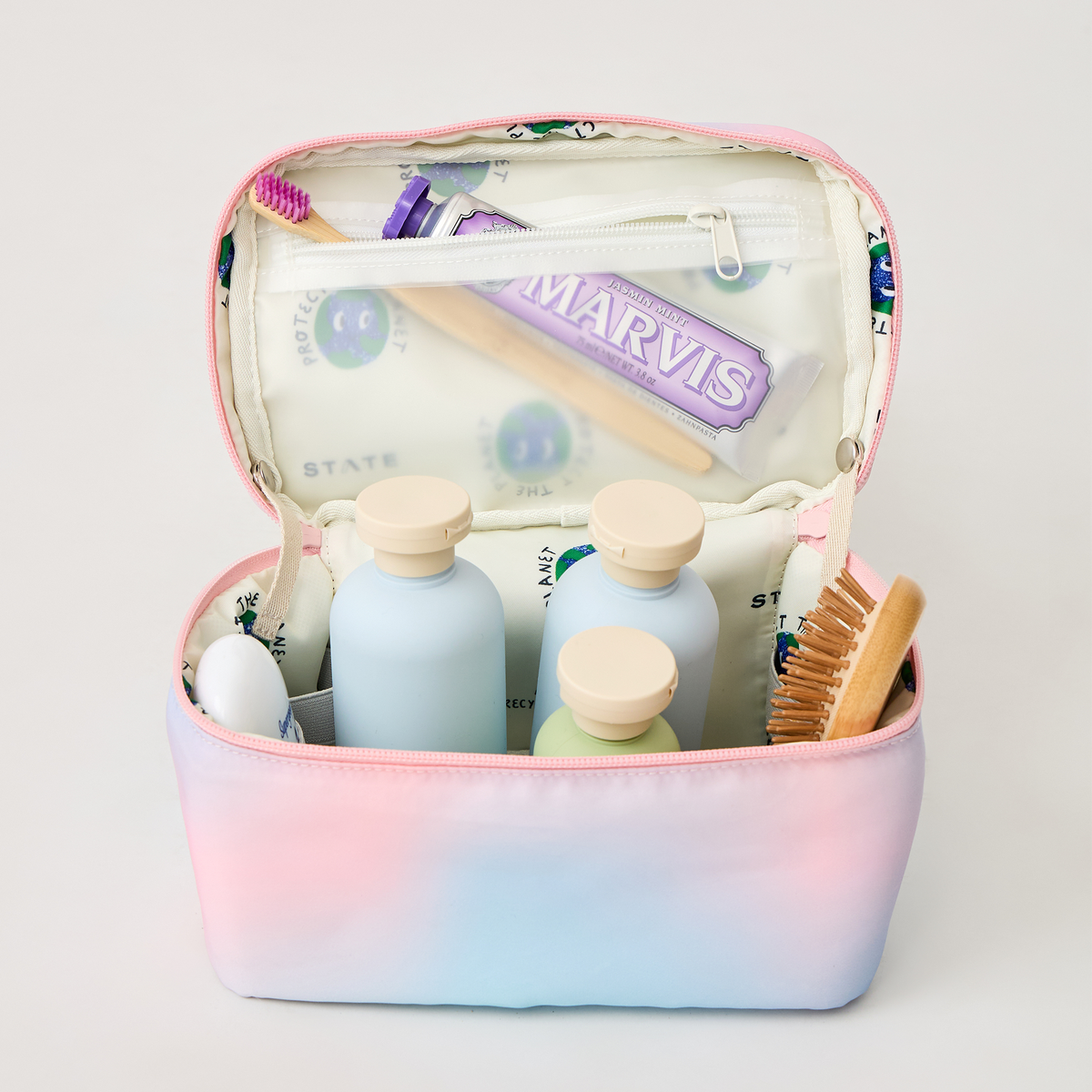 Image showing STATE Bags Kai Toiletry Kit Dreamy Floral Packed for a trip