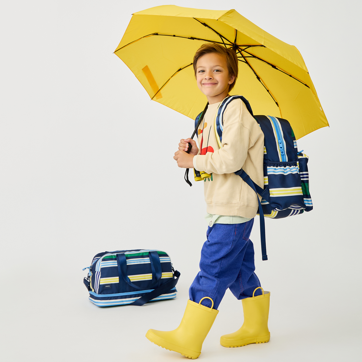 boy wearing STATE Bags Kane Backpack Polo Stripe