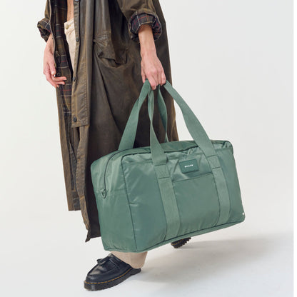 Woman carrying STATE Bags Wellington Weekender Click to Zoom