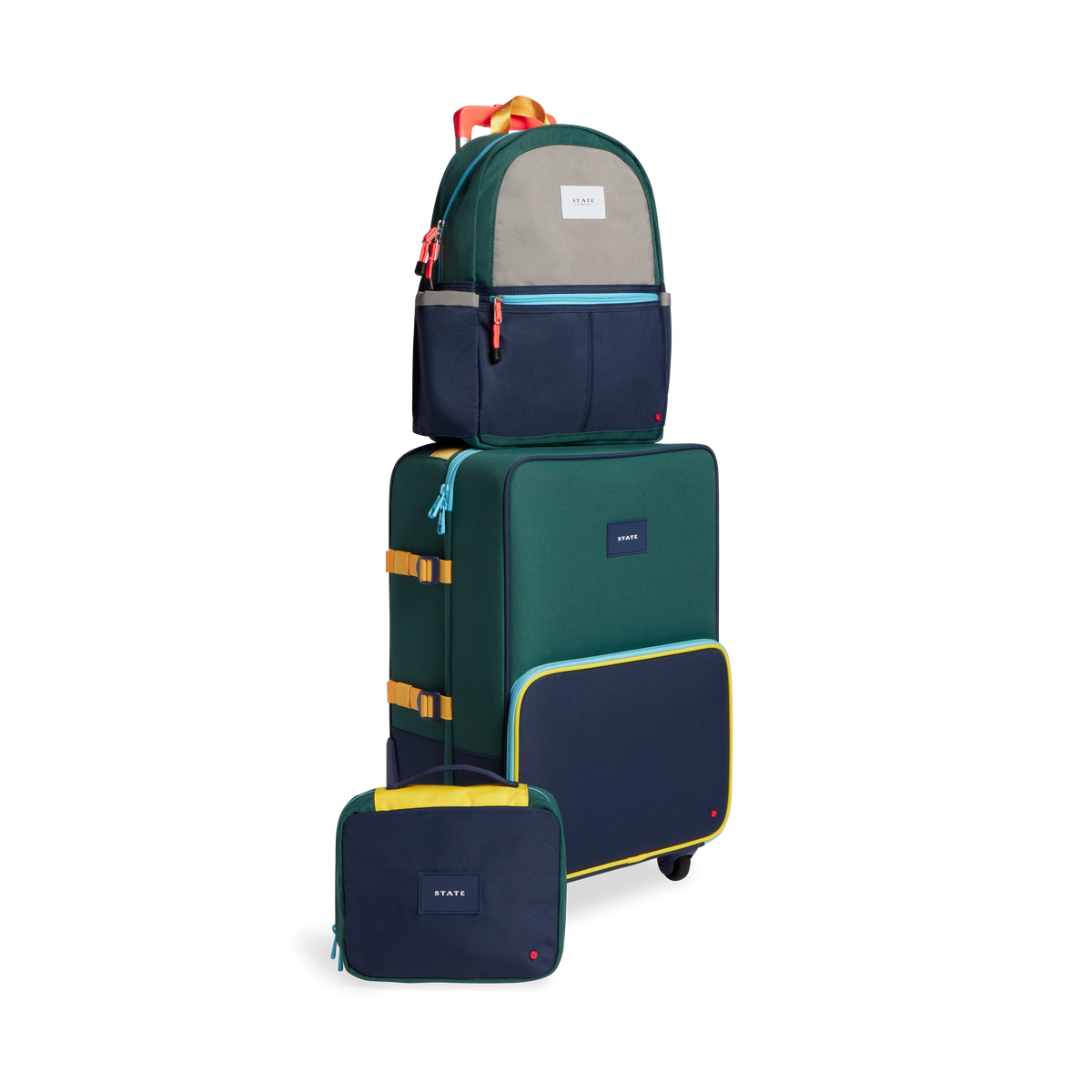 Product image of STATE Bags travel set in green/navy including, Logan suitcase, bensen toiletry bag, and Kane Kids Travel backpack