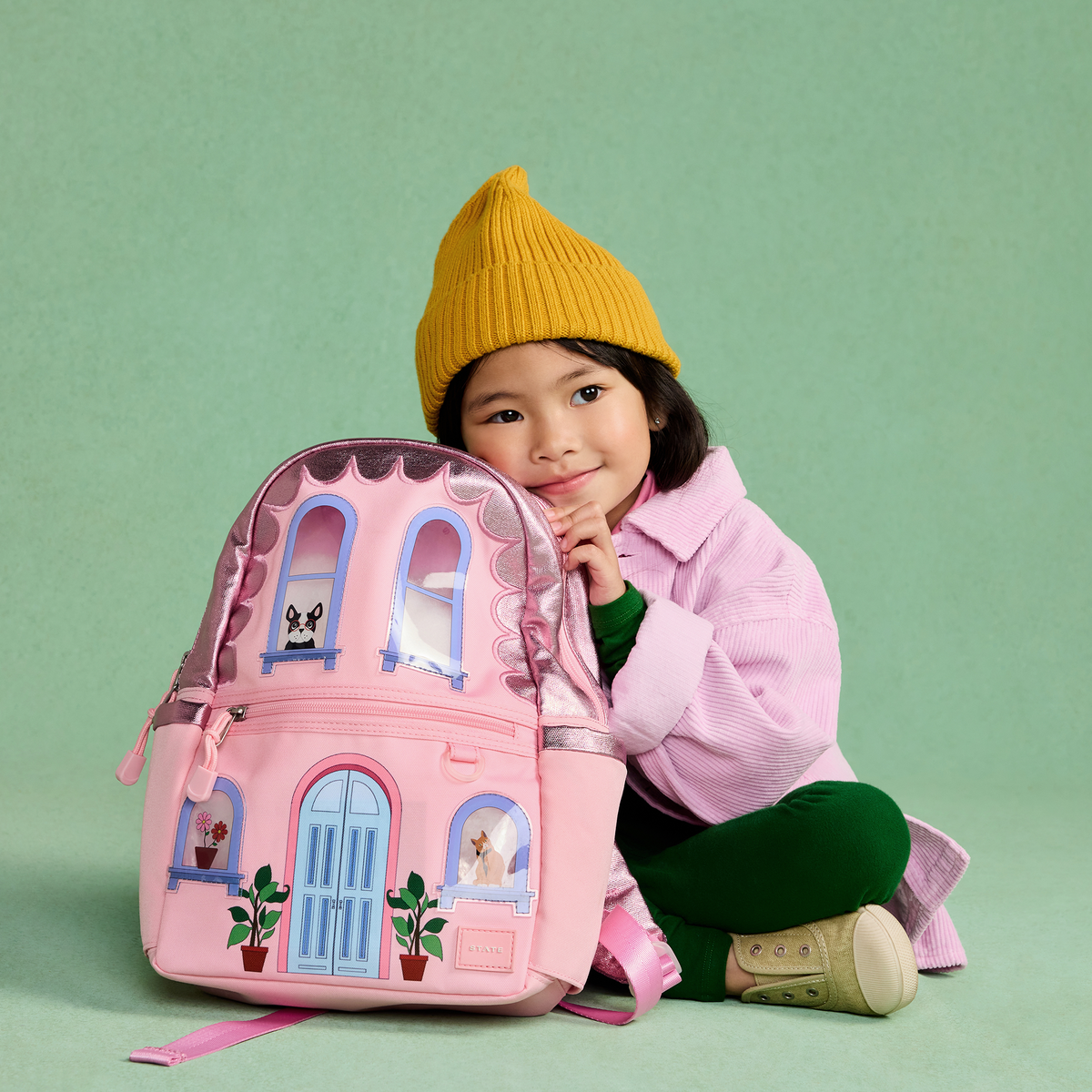 Girl sitting with STATE Bags Kane House