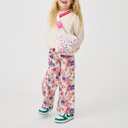 girl holding sunny kids fanny pack sprinkles