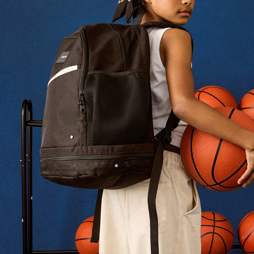 girl wearing STATE Bags Ozzie Ball Bag Black Front View Click to Zoom